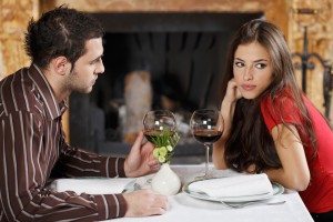 She feels bored with him. Couple's table near fireplace