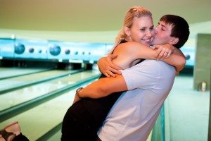 Pretty embracing couple in the bowling club.