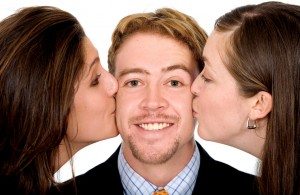 business man with two girls kissing him