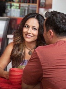 Skeptical Woman Looking at Man in Cafe