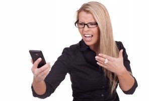 Frustrated woman looking at her mobile