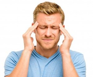 Worried young man suffering from headache