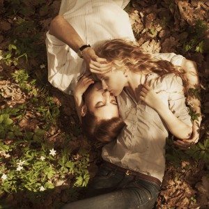beautiful couple lying in a meadow in spring