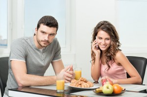 couple having breakfast, girl talking on the phone