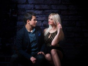 Young flirting couple, dark background