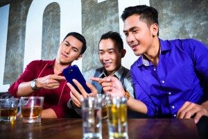 Asian friends drinking shots in nightclub