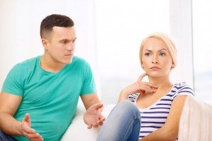 unhappy couple having argument at home