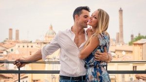 Beautiful casual young couple portrait outdoors in hotel terrace
