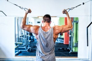 Bodybuilder working out the biceps in the gym. Sports concept