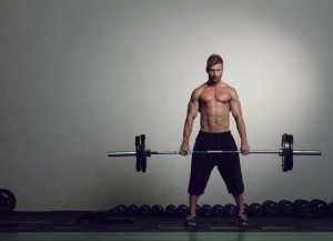 athletic young man lifting weights