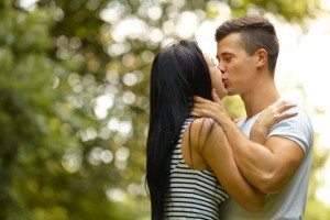 Kissing couple. Portrait of young caucasian couple kissing