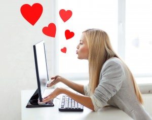 woman sending kisses with computer monitor