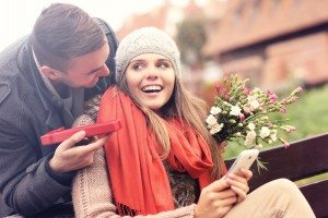 Man giving surprise gift to woman in the park