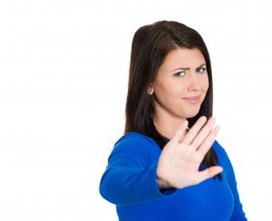 Annoyed young woman with bad attitude, giving talk to hand