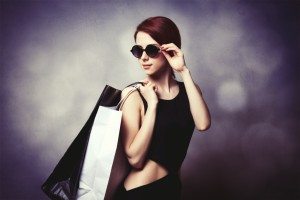 Style redhead girl with shopping bags