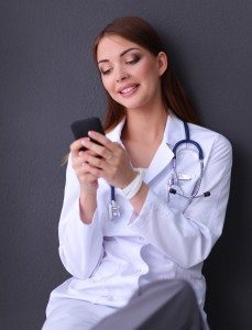 Young woman doctor sitting with your phone