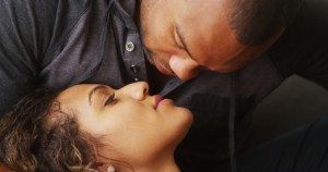Closeup of African boyfriend kissing his girlfriend