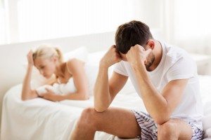 unhappy couple having problems at bedroom